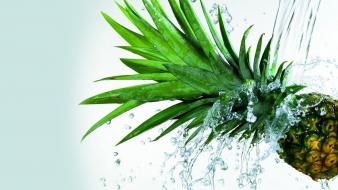 Pineapples splashes water white background wallpaper