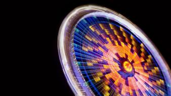 Black background ferris wheels lights long exposure multicolor wallpaper