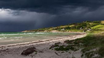 Beaches dark clouds grass hills houses wallpaper